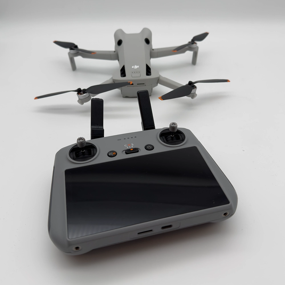 Le drone DJI Mini 4 Pro déployé au-dessus d'un paysage urbain, illustrant son utilisation facile pour les amateurs de drones et les professionnels de l'imagerie